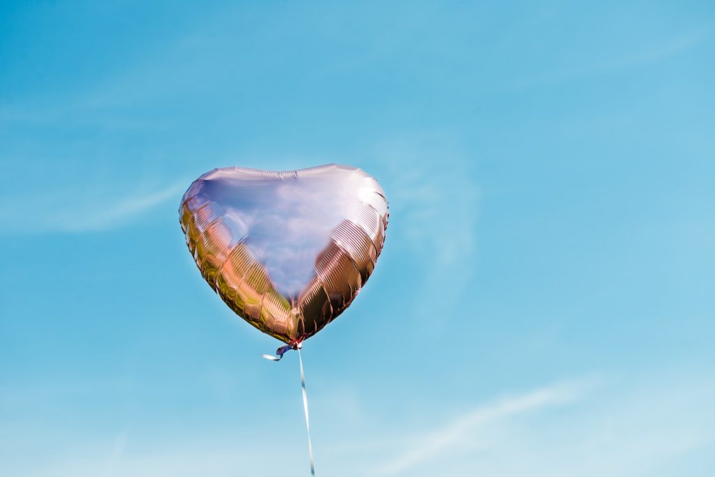 Heart shaped ballon on the sky background
