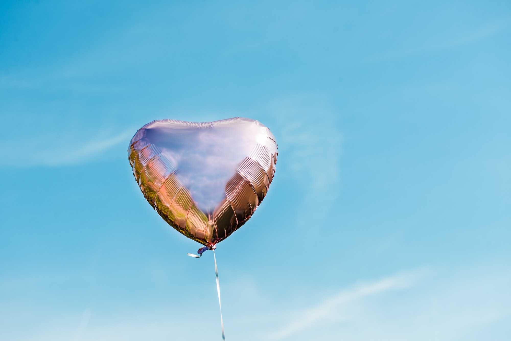 Heart shaped ballon on the sky background