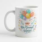 White ceramic mug featuring a pastel watercolor bouquet of balloons and the cursive phrase 'Un Grand Merci' in teal.